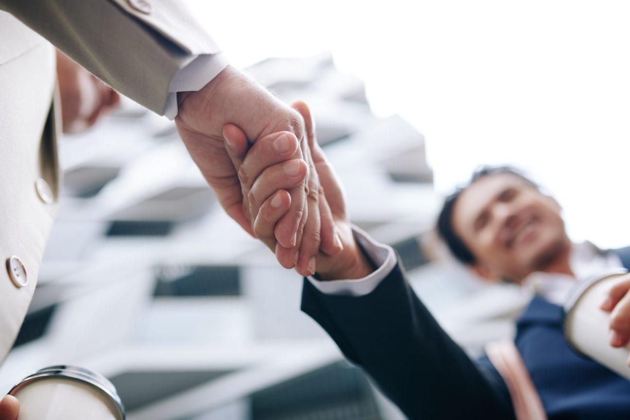 Close-up image of business partners shaking hands after having successful meeting